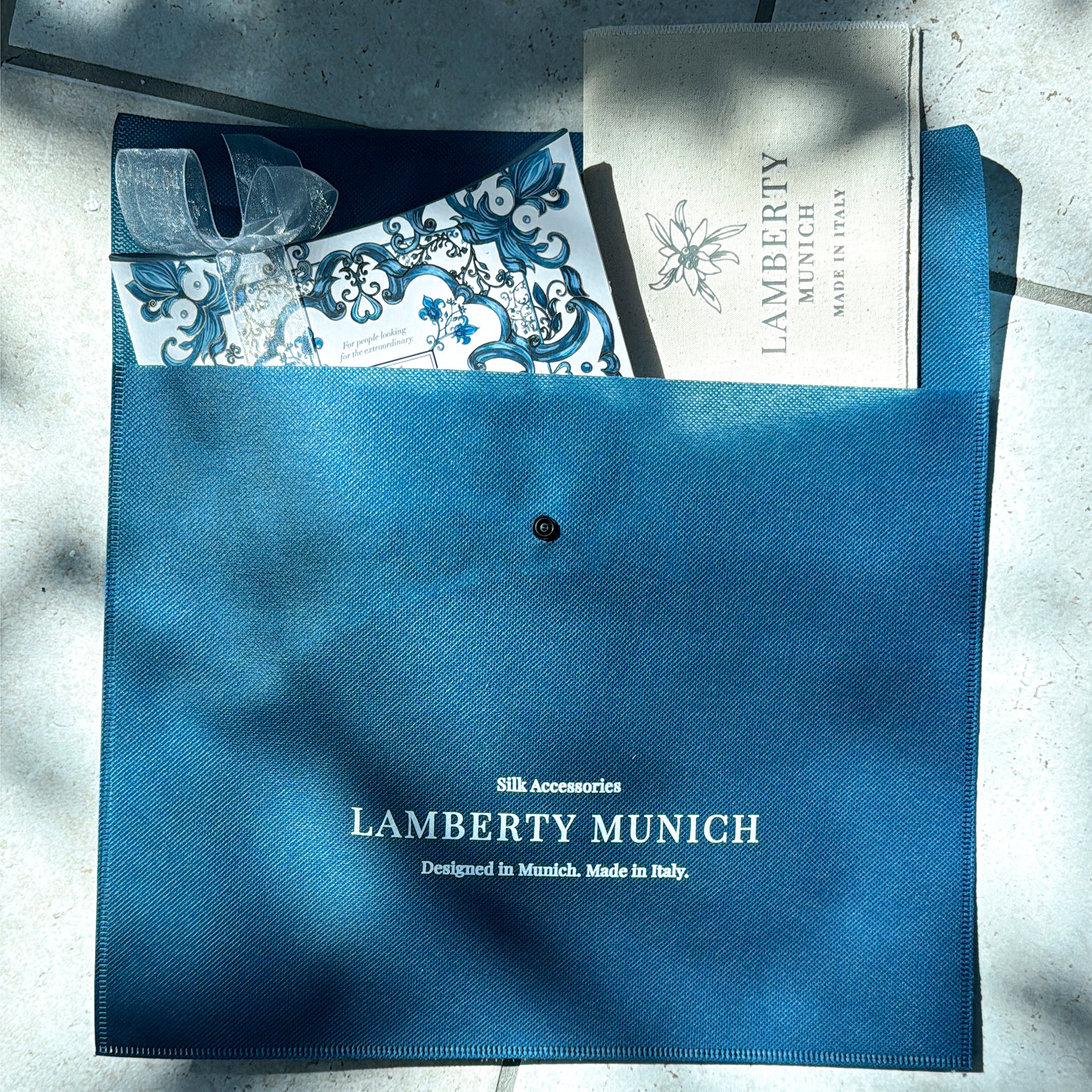 Blue Lamberty Munich scarf pouch with a printed Majolica card and a cream fabric envelope